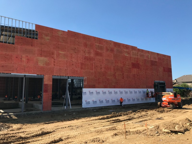 Metal-stud framed office build-out inside an industrial warehouse in Denton, Texas.
